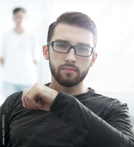 Fototapeta Naklejka Na Ścianę i Meble -  Handsome concentrated young man in glasses