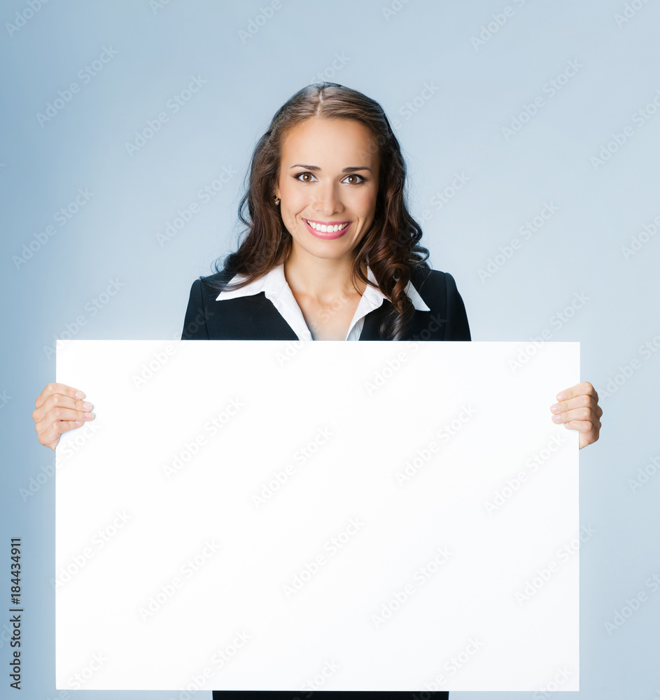 Businesswoman showing signboard, over blue Businesswoman showing signboard, over blue