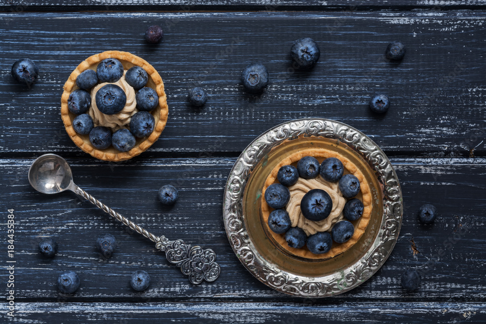 Cake with blueberries on a rustic background. View from above.