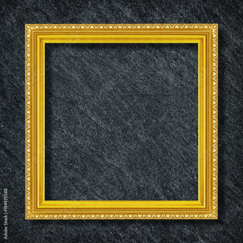 gold frame on Dark grey black slate background or texture.