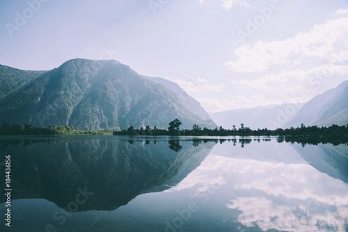 majestic mountains reflected in calm mountain lake in Altai, Russia
