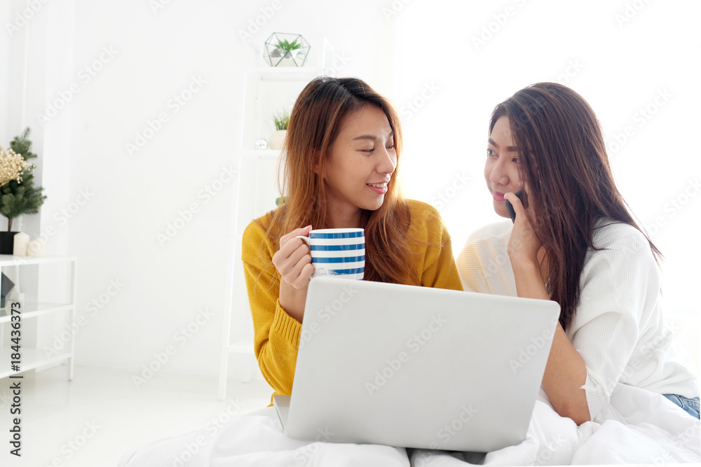 Young cute asia lesbian couple using laptop and smart phone with happiness at home, lgbt, homosexual, lesbian couple lifestyle Young cute asia lesbian couple using laptop and smart phone with happiness at home, lgbt, homosexual, lesbian couple lifestyle