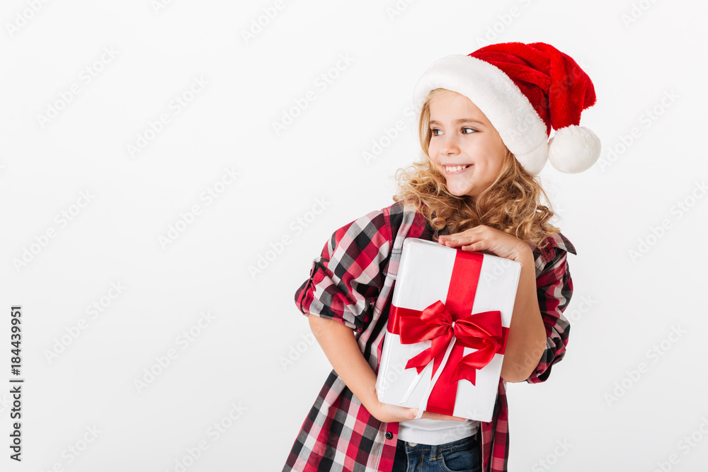 Portrait of a cheery little girl holding gift box Portrait of a cheery little girl holding gift box