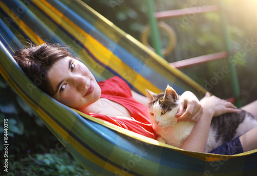 teen girl in hammock with cat close up summer outdoor photo photo