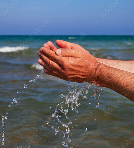 Hands with sea water.