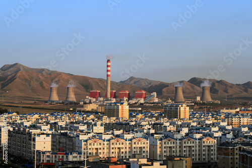 The Chinese city of Urumqi. Urban quarters and a huge thermal station in the background of the Tien-Shan mountains.