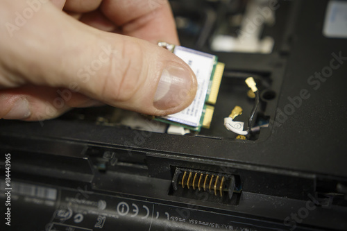 Laptop repair. Replacing parts in an old computer. Repair the electronics