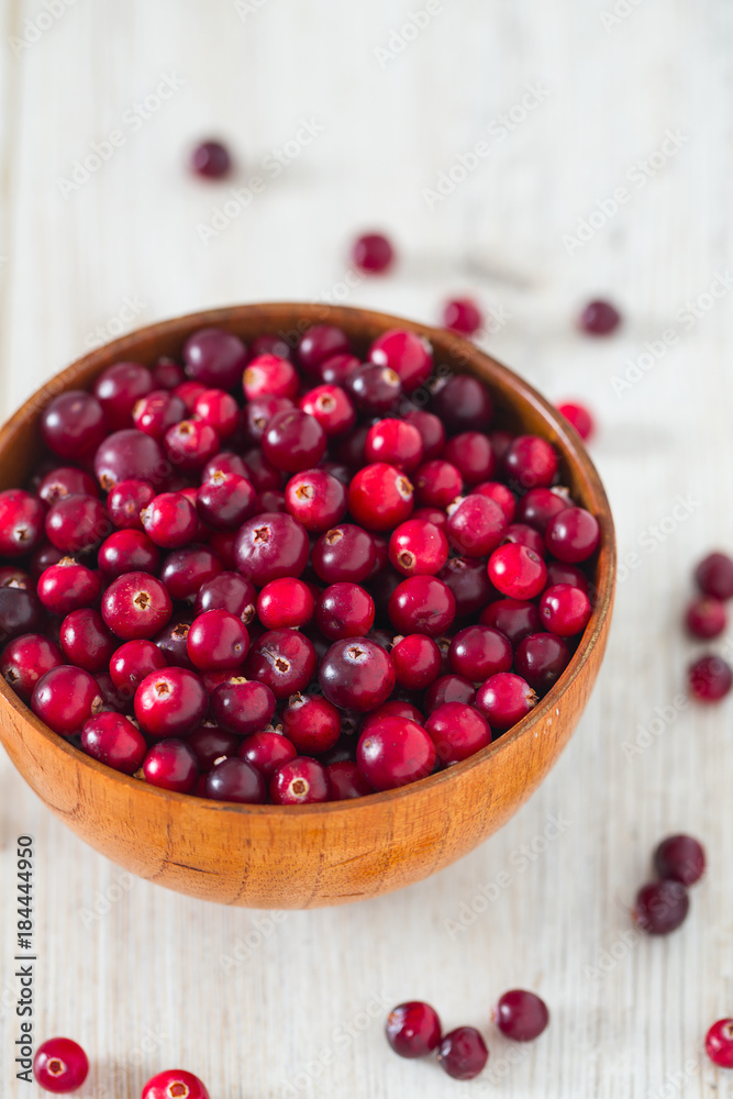 fresh cranberries on white wooden surface fresh cranberries on white wooden surface