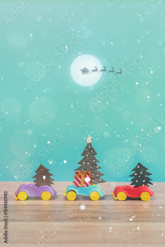 Toy Car with Christmas tree and gift box. Christmas landscape with gifts and snow. Merry christmas and happy new year greeting card with copy-space. Christmas celebration holiday background.