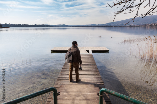 Man taking photo and relaxing at the lake of Annone in italy	 photo