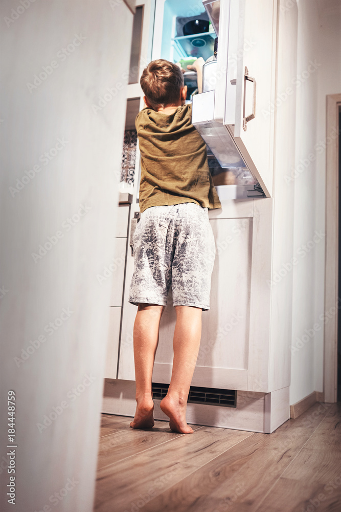 Little boy try to take somthing for eat from rifregerator Little boy try to take somthing for eat from rifregerator
