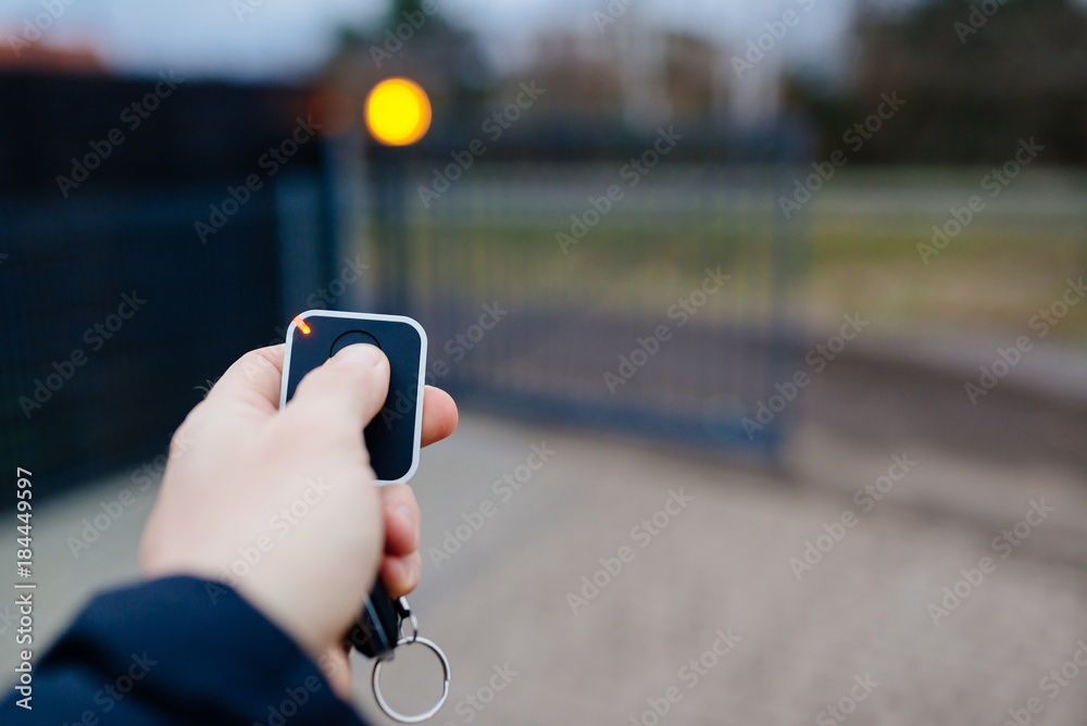 Man opening automatic property gate