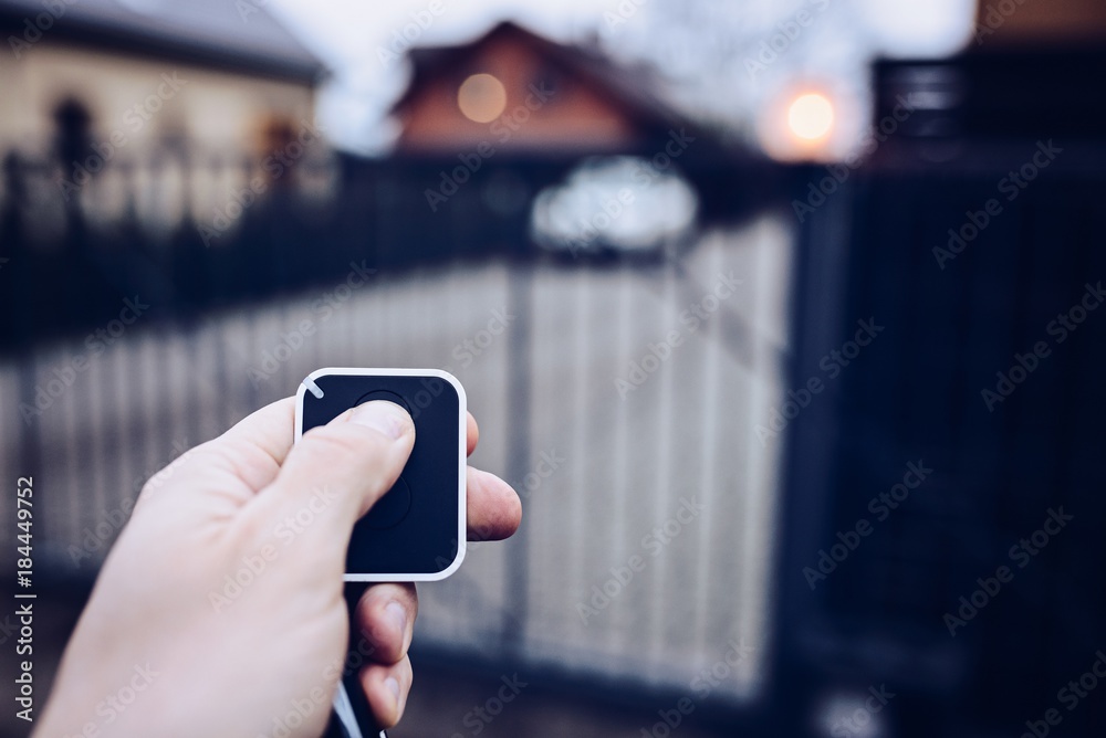 Man opening automatic property gate