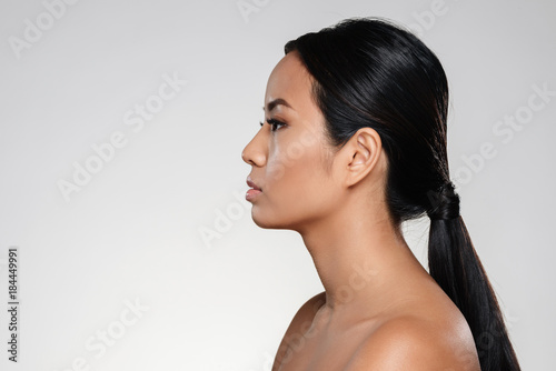 Side view portrait of a young half naked asian woman