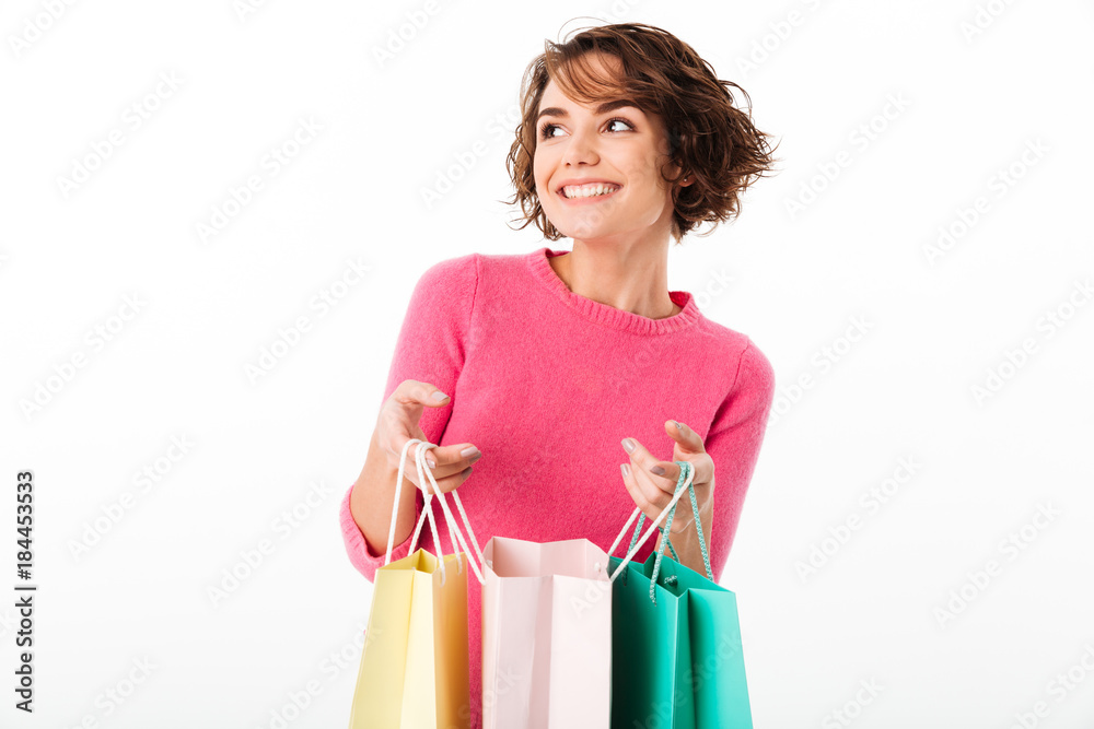 Happy cheerful young woman holding shopping bags. Happy cheerful young woman holding shopping bags.