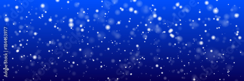 Christmas panoramic background. White snow flakes on a blue background. New Year`s illustration.