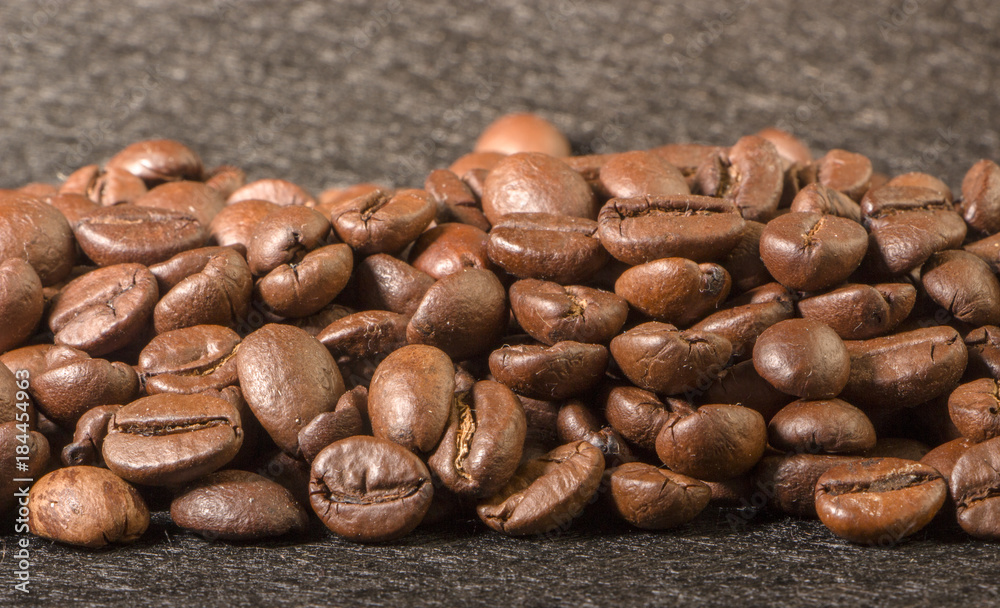 texture of coffee, with beautiful patches of light on the surface of grains texture of coffee, with beautiful patches of light on the surface of grains