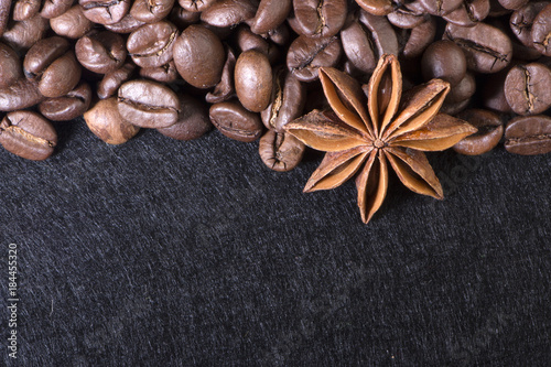 star anise, on the background of coffee with beautiful highlights on the surface of grains photo