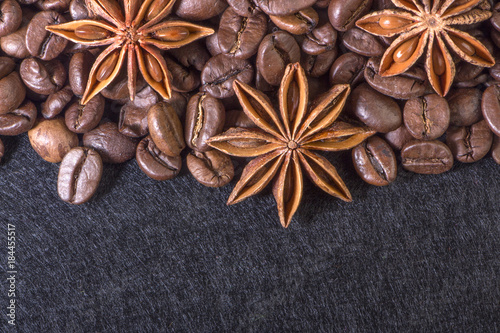 star anise, on the background of coffee with beautiful highlights on the surface of grains