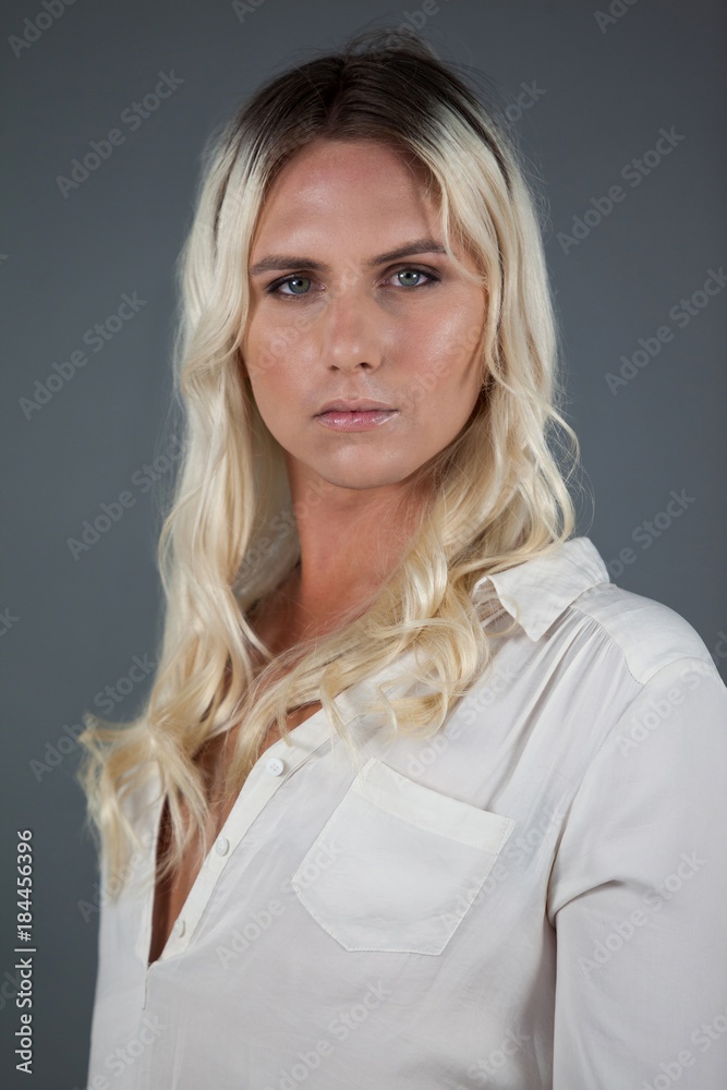 Transgender woman standing over gray background Transgender woman standing over gray background