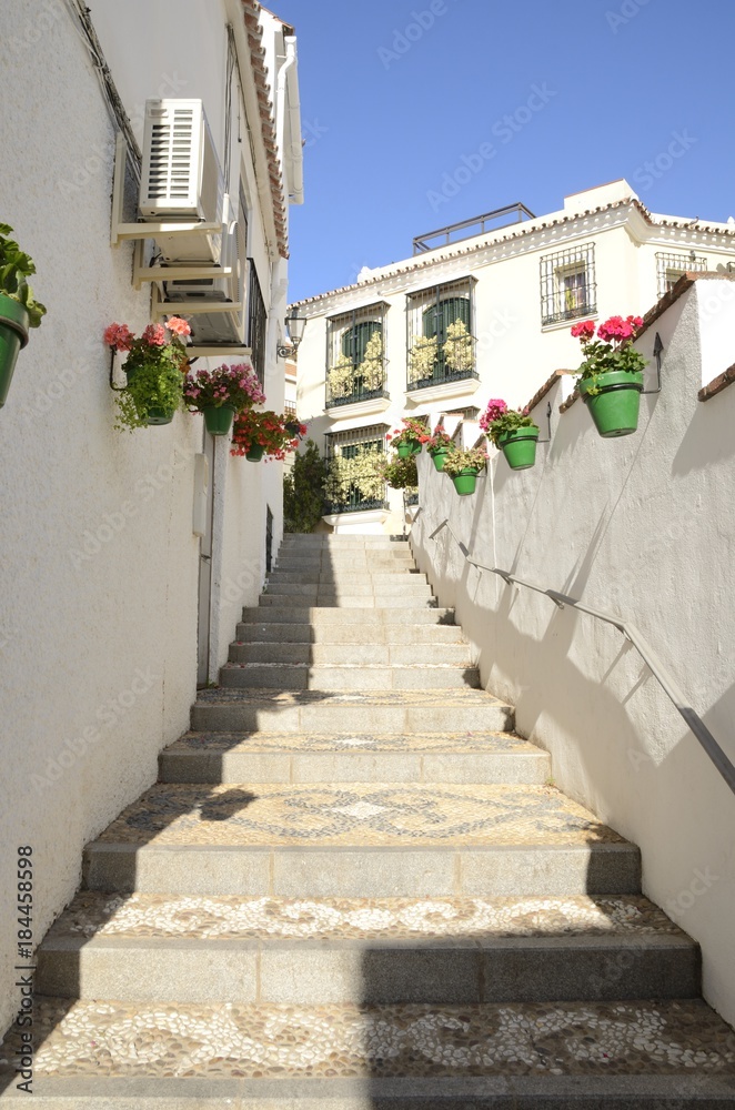 Naklejka premium Stairs along the alley in Estepona, Andalusia, Spain