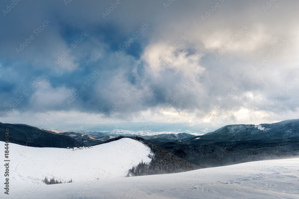Fantastic landscape with snowy mountains, trees and house. Carpathian mountains, Ukraine, Europe