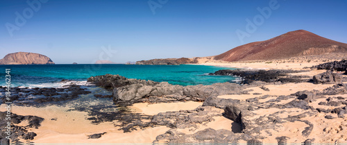 Las conchas beach. Canary islands. Sunny wild bech in La Graciosa. Lanzarote. White sand and turquoise waters