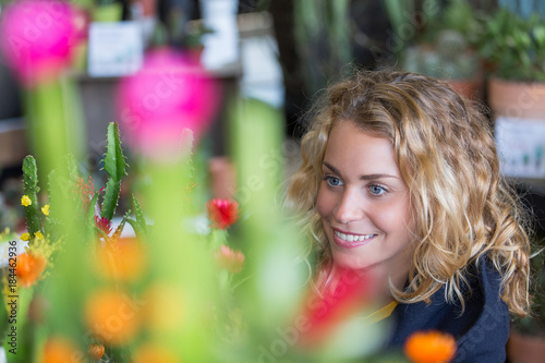 young woman buying grasy plants photo