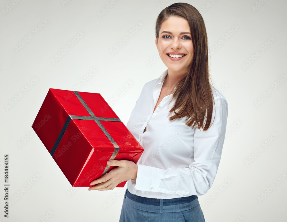 Smiling woman in white shirt holding big red gift box. Smiling woman in white shirt holding big red gift box.
