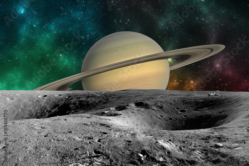 Planet Saturn from Saturn moon surface. Elements of this image furnished by NASA