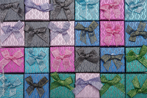 Background of colored square gift boxes with bows.