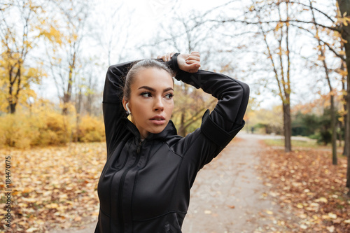 Portrait of a confident fitness girl in earphones