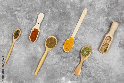 Various spices on a gray background. Top view. Food background