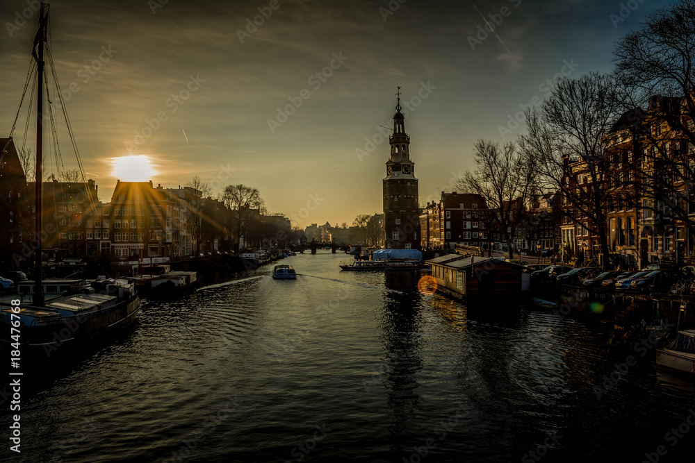 Sunset in the beautiful city of dams known as Amsterdam, the capital of Netherlands Sunset in the beautiful city of dams known as Amsterdam, the capital of Netherlands