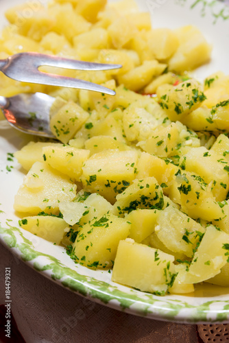 Side dish of boiled potatoes with parsley