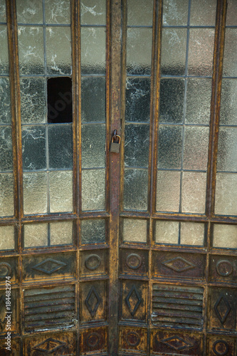 old doors with broken windows and spider web