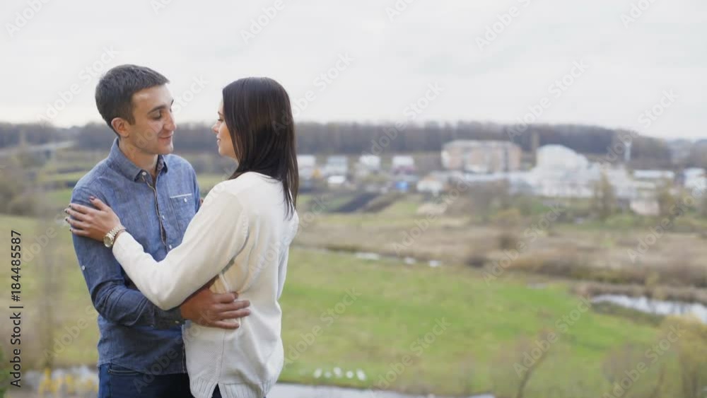 Lovely couple talking softly on the cliff of the mountain. 4K Lovely couple talking softly on the cliff of the mountain. 4K