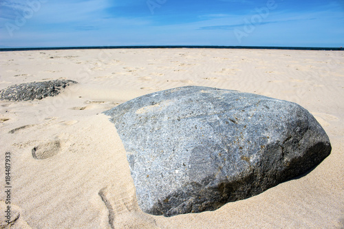 Big stone on the beach in the sand