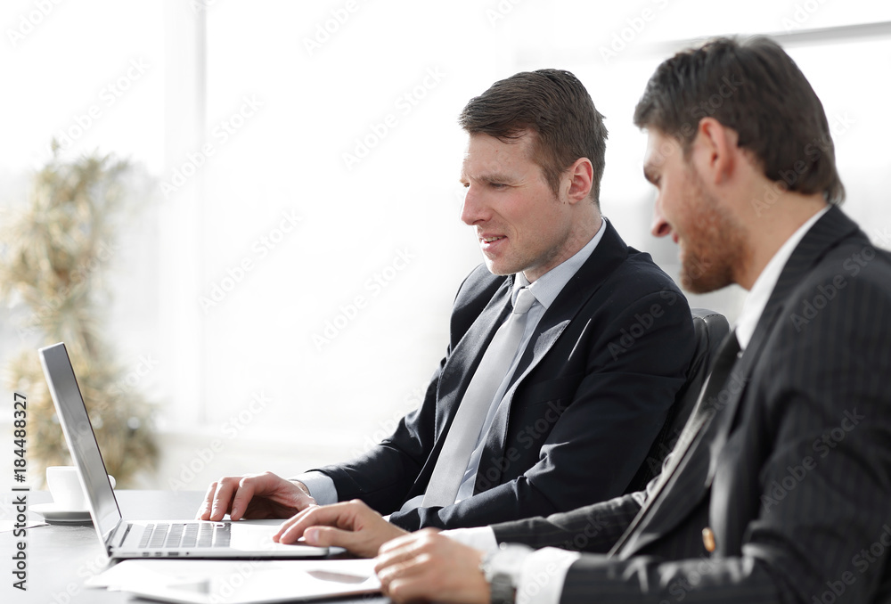 close-up.businessman working with laptop at his Desk. close-up.businessman working with laptop at his Desk.