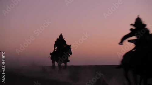 Horsemen warriors silhouetted, Medieval Cavalry attacks the Enemy photo