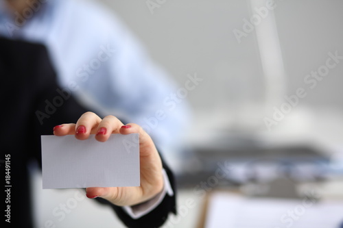Woman hand giving business card in office