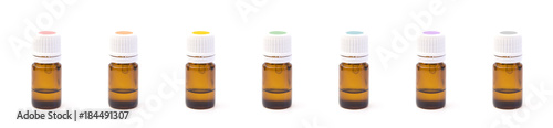 Row of Various Colored Essential Oil Bottles with Rainbow Colored Labels