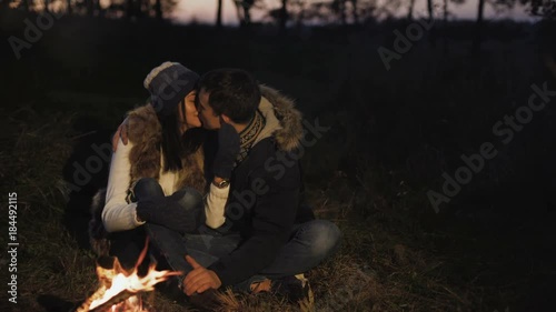 Wallpaper Mural Romantic couple resting at bonfire, talking, kissing and caressing Torontodigital.ca