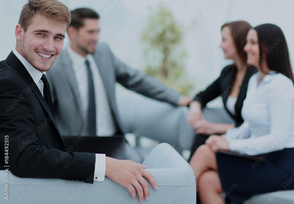 Group of young business people gathered together discussing crea Group of young business people gathered together discussing crea