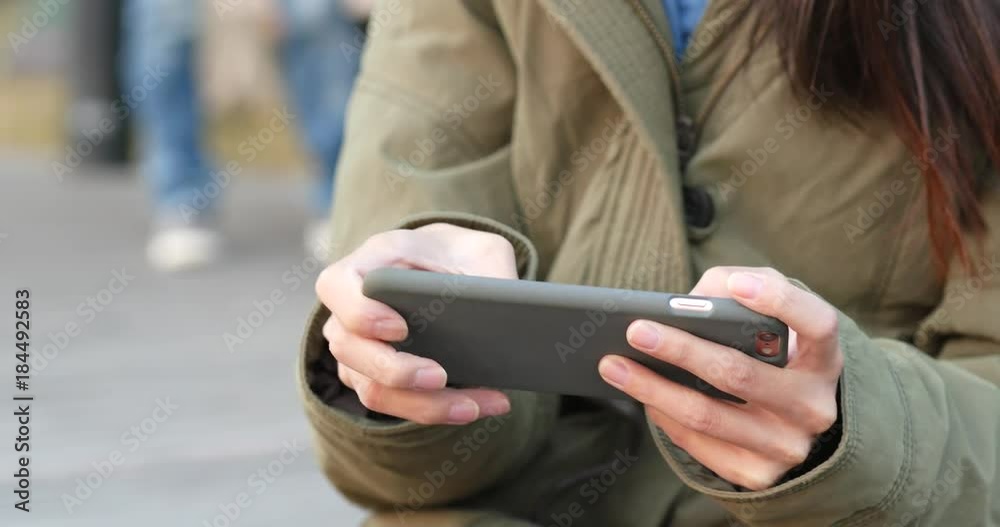Woman play game on smart phone Woman play game on smart phone
