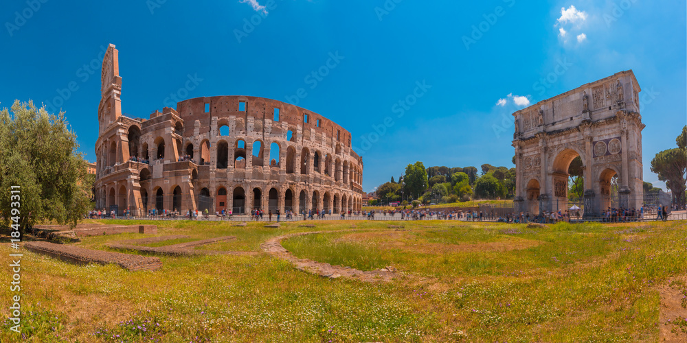 Panorama of The Arch of Titus and Colosseum or Coliseum, also known as the Flavian Amphitheatre, the largest amphitheatre ever built, in the centre of the old city of Rome, Italy.
