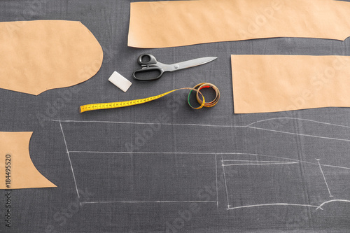 Grey fabric and sewing accessories on table, top view