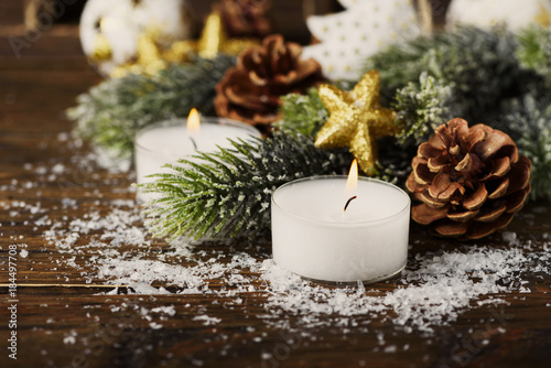 Christmas ornament with cone, candles and snow, selective focus