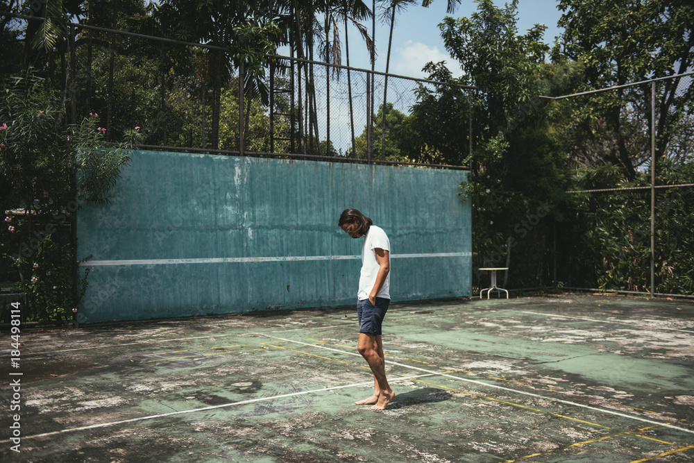 Man standing in a tennis court Man standing in a tennis court