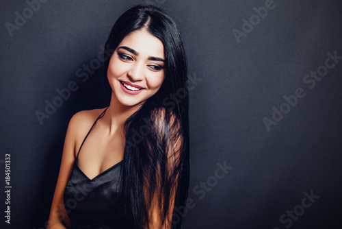 Wallpaper Mural Beautiful woman with black straight hair  on a dark background smiling. Close-up. Space for text
 Torontodigital.ca